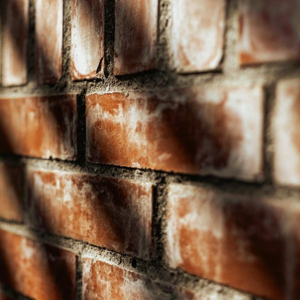 Shadow of a person doing exercises on a dark wall